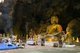 Thailand: Worshipper in front of a large seated Buddha inside Tham Khao Luang, Phetchaburi